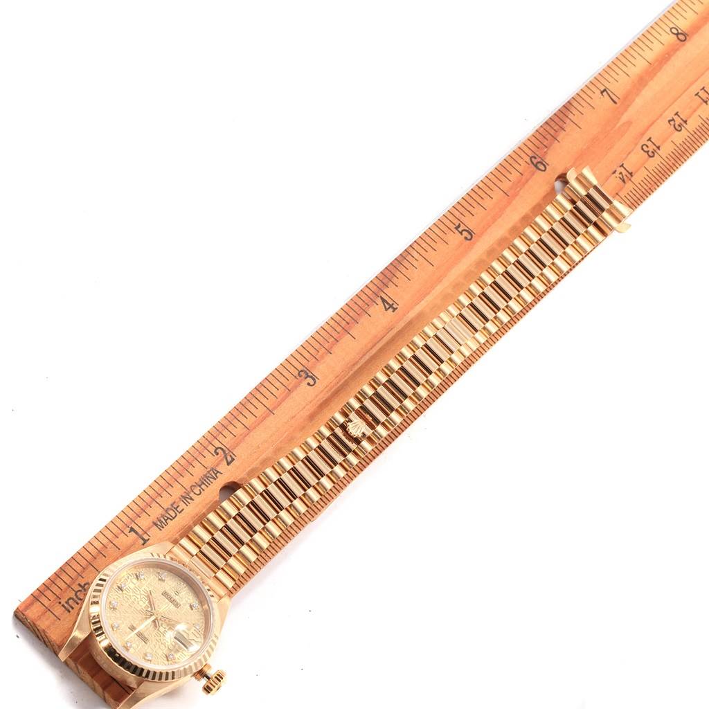 The image shows a Rolex President 69178 Women
s Yellow Gold Champagne Dial 69178 Women
s Yellow Gold Champagne Dial model watch laid flat beside a ruler for measurement.