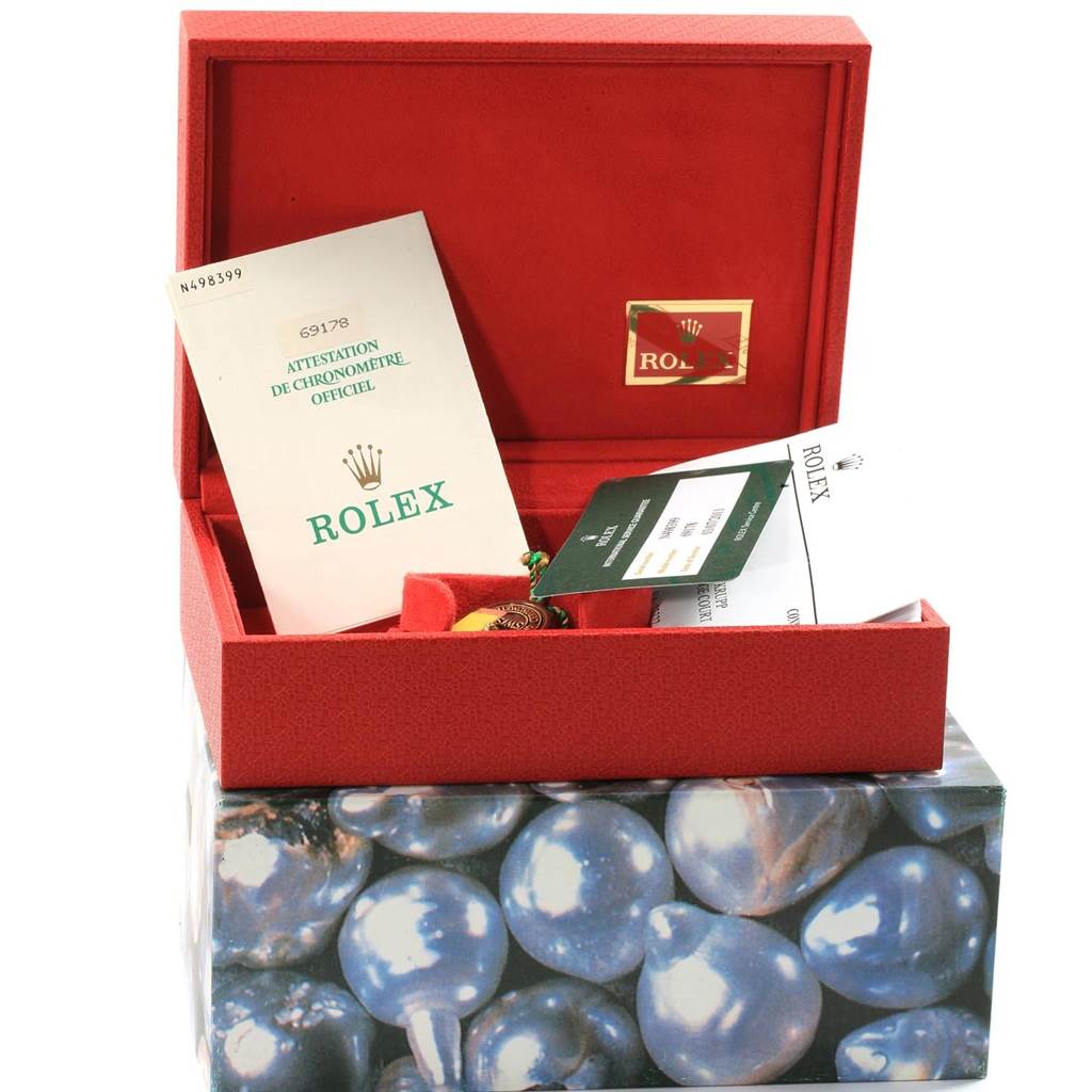 The image shows a Rolex President 69178 Women's Yellow Gold Black Dial 69178 Women's Yellow Gold Black Dial model watch box with its open lid revealing certification and warranty documents.