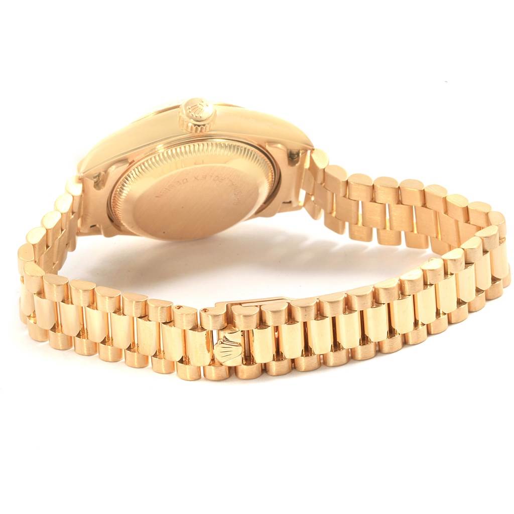 This image shows the back case and bracelet of a Rolex President 69178 Women's Yellow Gold Black Dial 69178 Women's Yellow Gold Black Dial model watch at an angle.