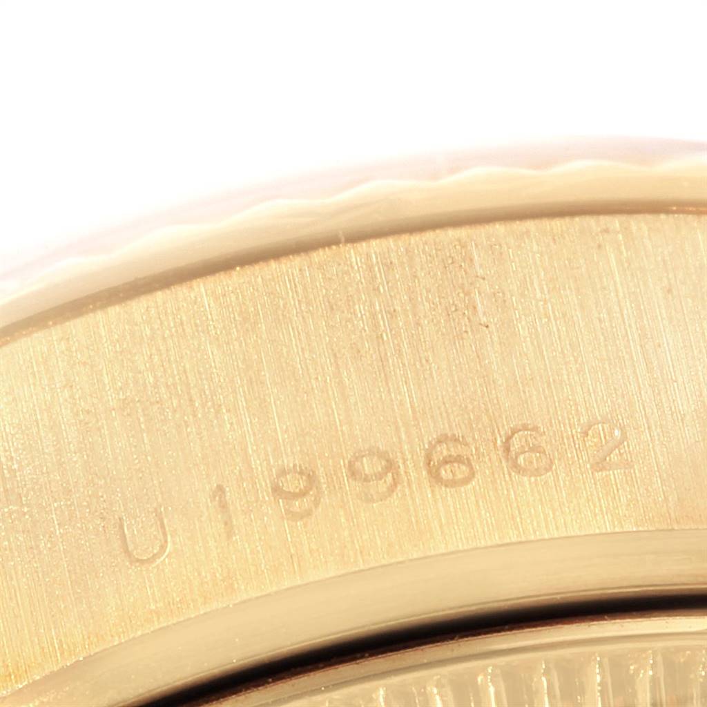 This close-up image shows part of the case and a serial number of a Rolex President 79178 Women's Yellow Gold Champagne Dial 79178 Women's Yellow Gold Champagne Dial model watch.