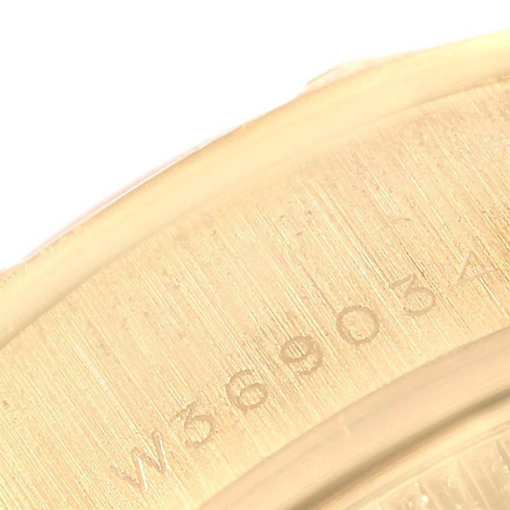 This image shows a close-up of the serial number on the gold casing of a Rolex President 69258 Women's Yellow Gold Champagne Dial 69258 Women's Yellow Gold Champagne Dial model watch.