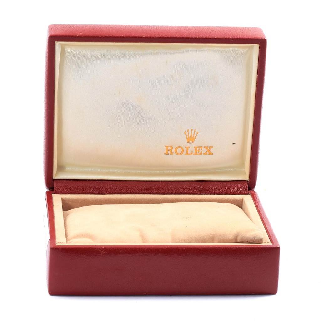 The image shows an open red Rolex box for the President model, featuring the logo and cushion.