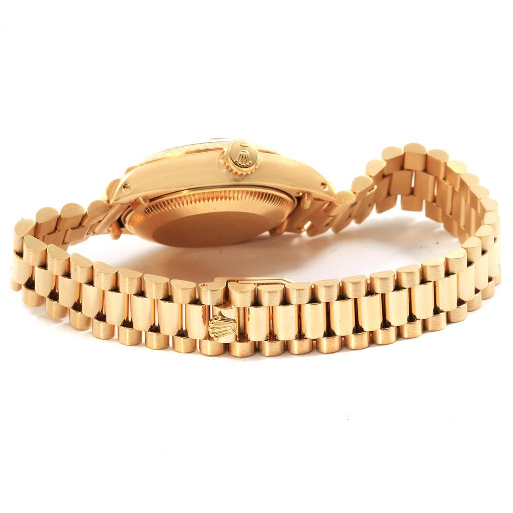 This image shows the side and back view of a gold Rolex President 6917 Women's Yellow Gold Brown Dial 6917 Women's Yellow Gold Brown Dial model watch, highlighting its bracelet and clasp.