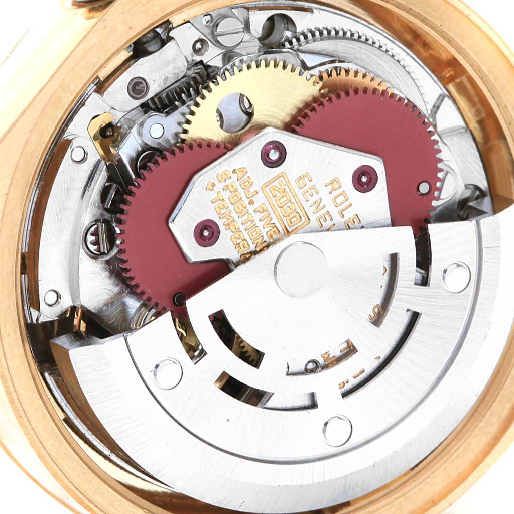 The image shows the inner mechanism of a Rolex President 6917 Women's Yellow Gold Brown Dial 6917 Women's Yellow Gold Brown Dial model watch, focusing on the movement and gears.