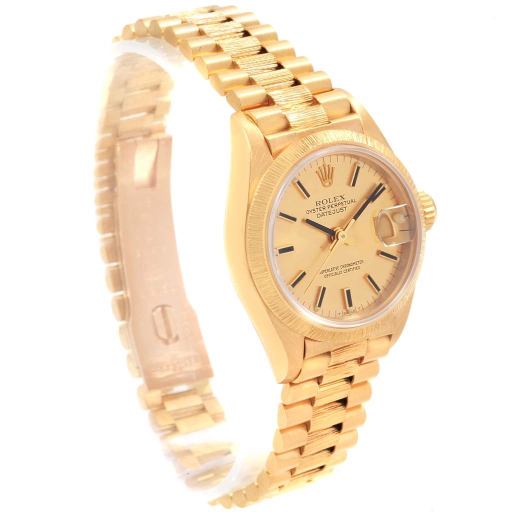 The image shows a side angle of a gold Rolex President 69278 Women
s Yellow Gold Champagne Dial 69278 Women
s Yellow Gold Champagne Dial model, displaying its dial, bezel, crown, and bracelet.