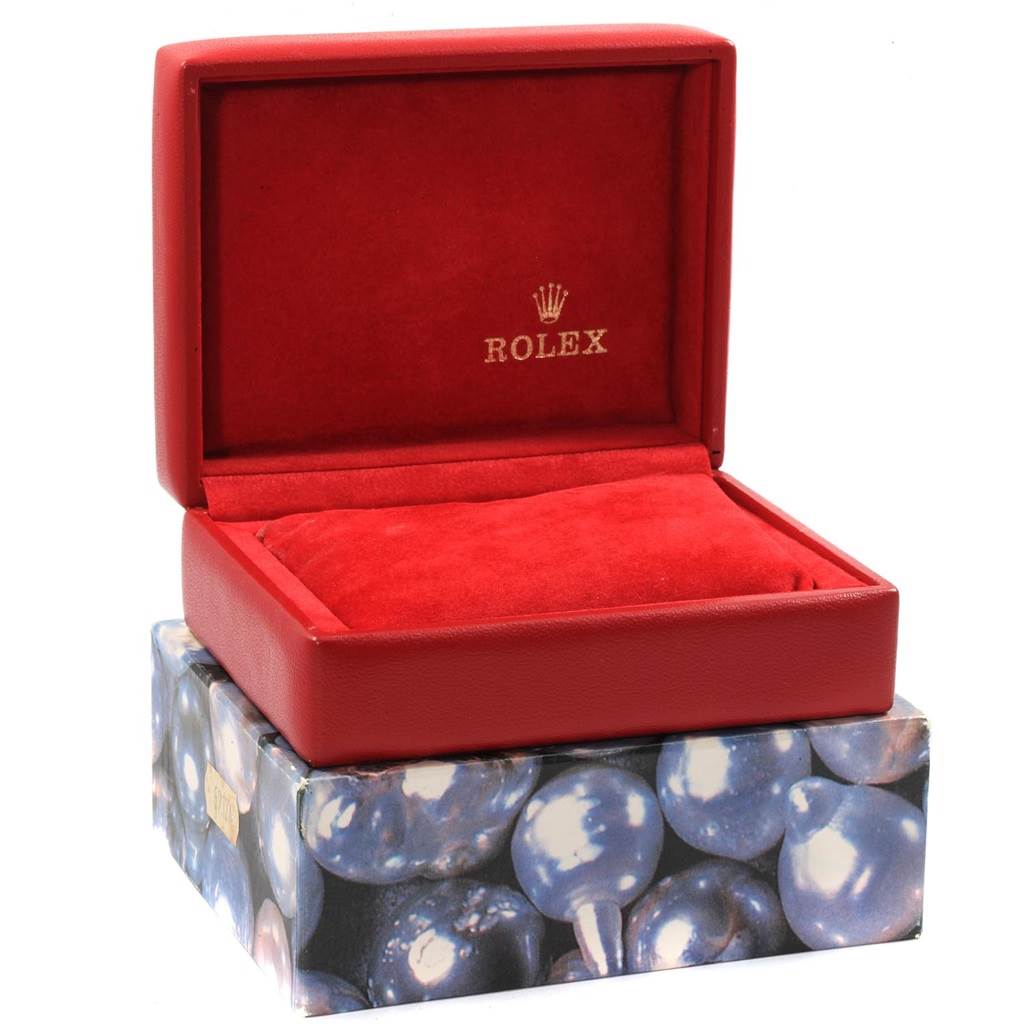 The image shows an open red Rolex watch box with the brand logo, designed for the President model by Rolex.