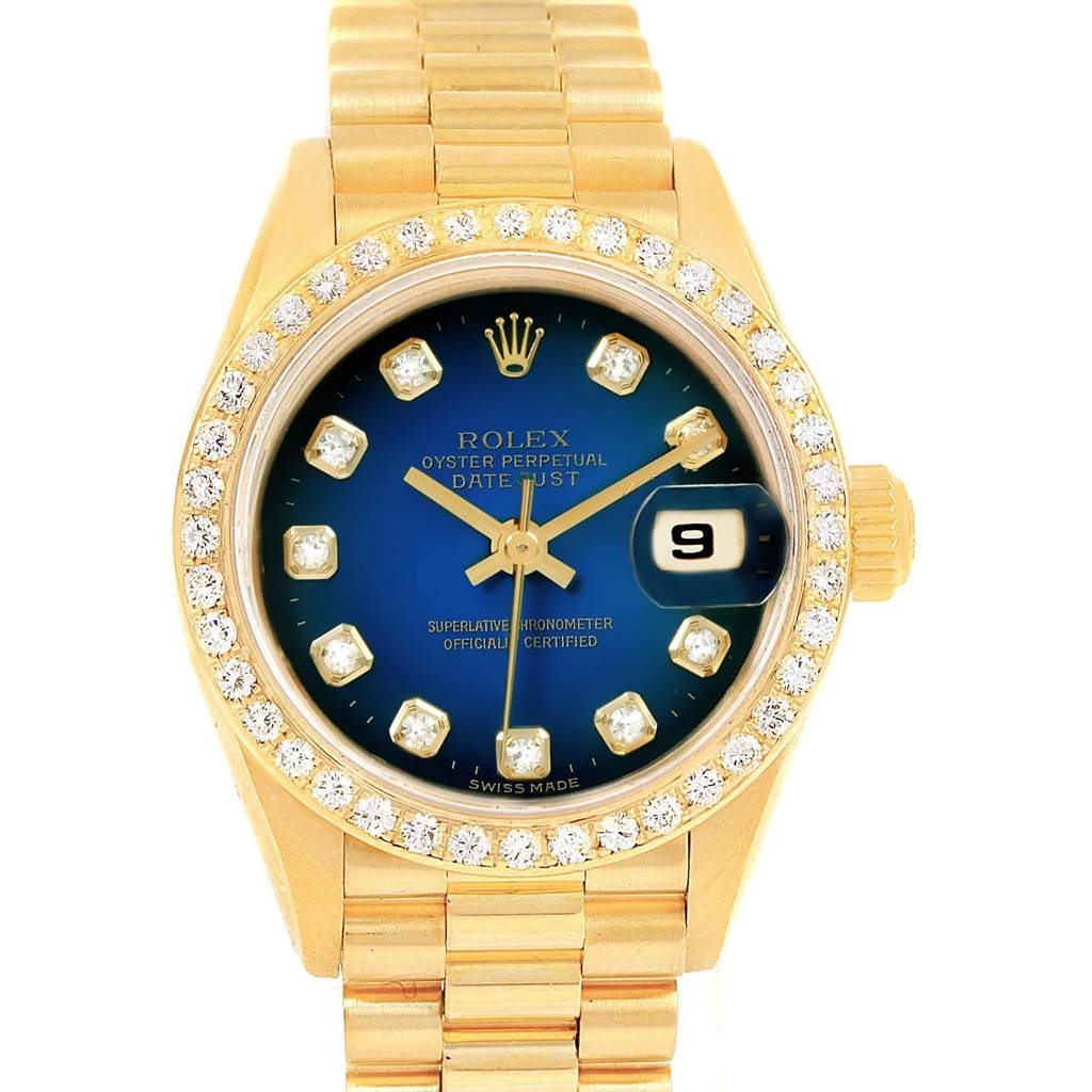 The image shows a Rolex President 69138 Women's Yellow Gold Blue Dial 69138 Women's Yellow Gold Blue Dial model watch from the front, featuring a diamond bezel, blue dial, and gold bracelet.
