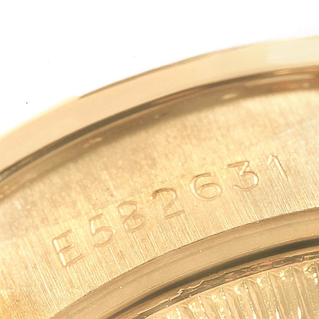 The image shows a close-up of the engraving on the back of the Rolex President 69138 Women's Yellow Gold Blue Dial 69138 Women's Yellow Gold Blue Dial model watch.