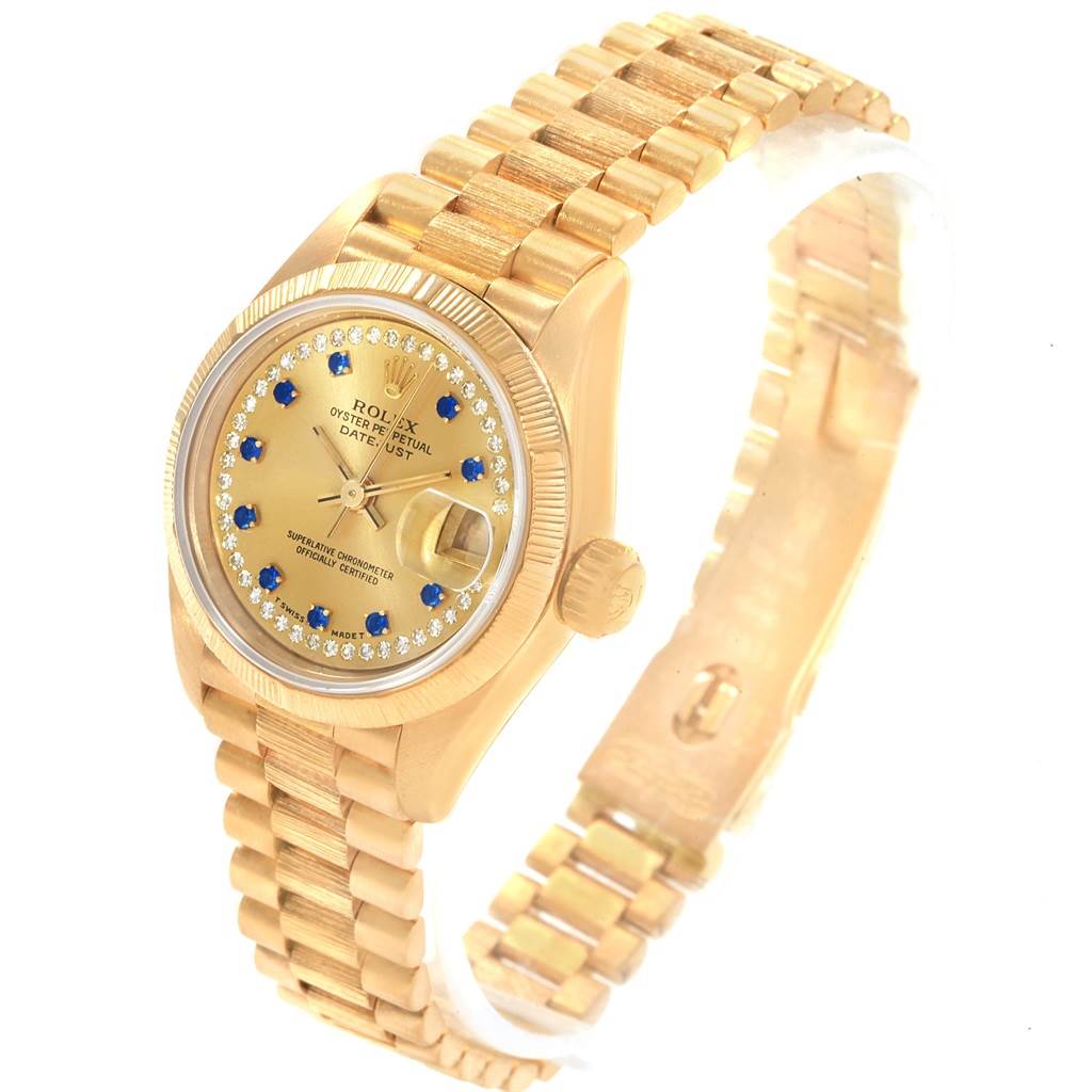 This image shows a gold Rolex President 69038 Women's Yellow Gold Champagne Dial 69038 Women's Yellow Gold Champagne Dial model watch at an angle displaying the face, bezel, bracelet, and crown.