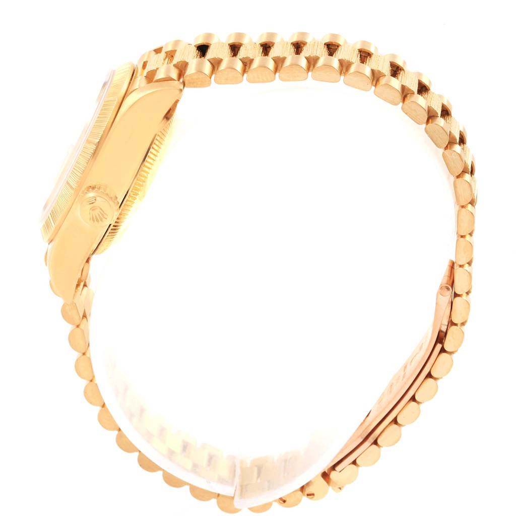 The image shows a side view of a Rolex President 69278 Women
s Yellow Gold Champagne Dial 69278 Women
s Yellow Gold Champagne Dial model watch featuring its case, crown, and distinct bracelet design.