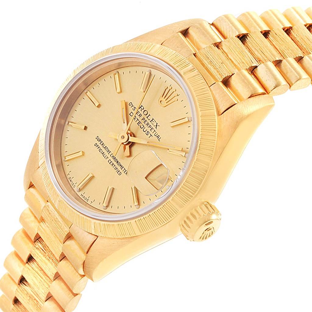 This image shows a Rolex President 69278 Women
s Yellow Gold Champagne Dial 69278 Women
s Yellow Gold Champagne Dial model watch from an angled view, highlighting its dial, bezel, crown, and part of the bracelet.