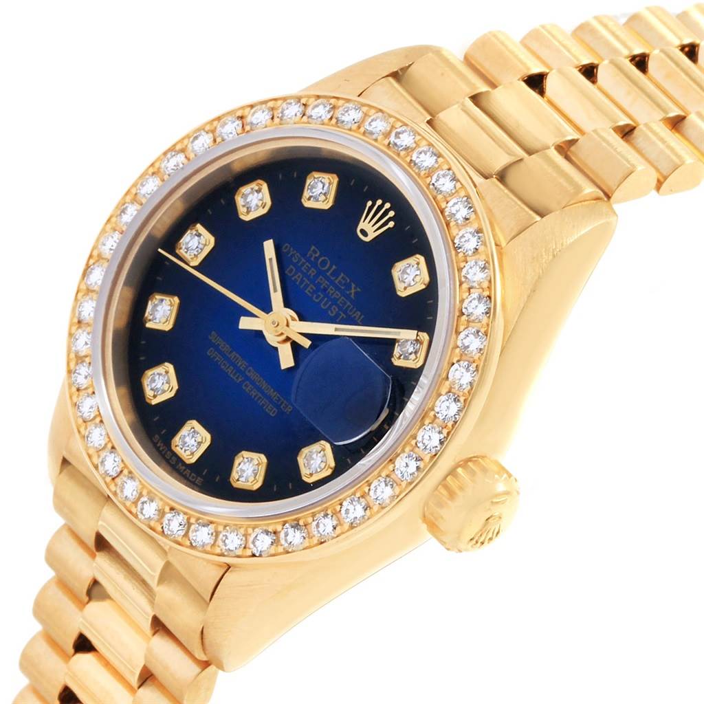 The image shows a close-up angled view of the Rolex President 69178 Women's Yellow Gold Blue Dial 69178 Women's Yellow Gold Blue Dial model watch, highlighting its gold case, diamond bezel, and bracelet.