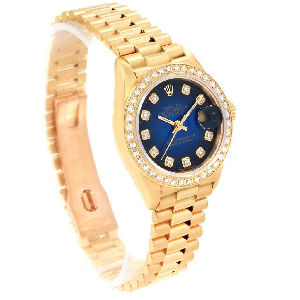 The image shows the front angle of a Rolex President 69178 Women's Yellow Gold Blue Dial 69178 Women's Yellow Gold Blue Dial model watch, highlighting its golden band, blue dial, and diamond-encrusted bezel.