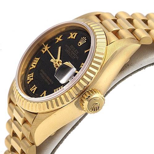 The image shows a side angle of a Rolex President 69068 Women's Yellow Gold Black Dial 69068 Women's Yellow Gold Black Dial model watch, highlighting the gold crown, fluted bezel, black dial, and part of the bracelet.