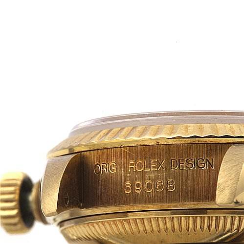 This image shows a close-up side angle of the Rolex President 69068 Women's Yellow Gold Black Dial 69068 Women's Yellow Gold Black Dial model, showcasing the crown and part of the case with the model number engraved.
