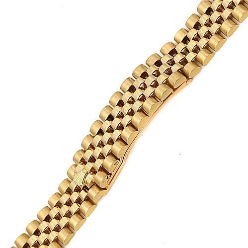This image shows a close-up of the gold bracelet of a Rolex President 69178 Women
s Yellow Gold Champagne Dial 69178 Women
s Yellow Gold Champagne Dial model watch from a top-down angle.