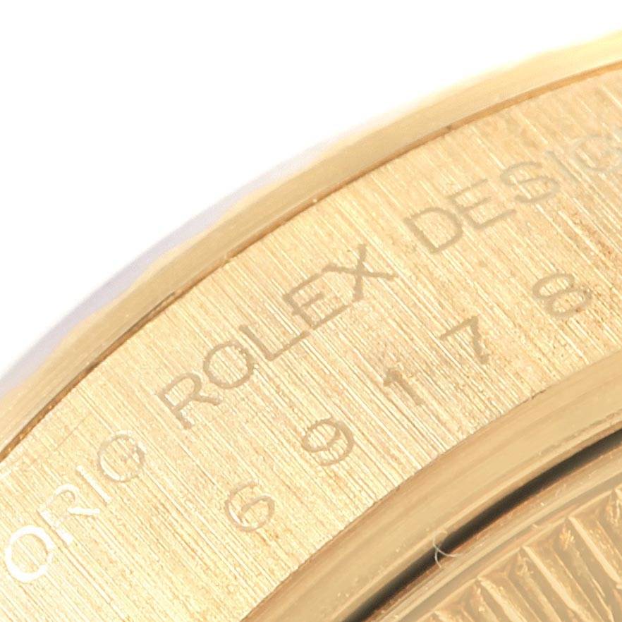 The image shows a close-up of the engraved side of the Rolex President 69178 Women's Yellow Gold White Dial 69178 Women's Yellow Gold White Dial model watch case.