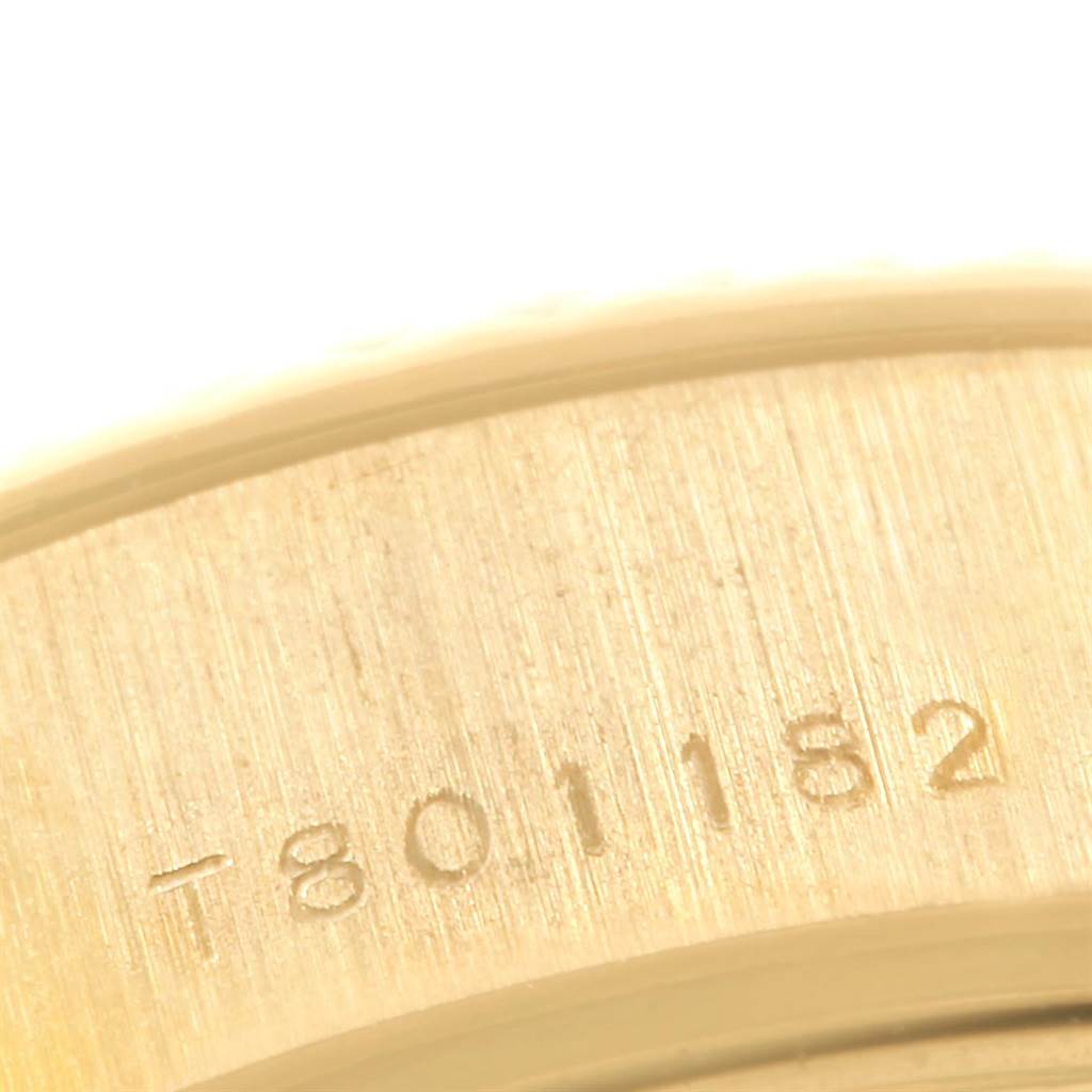 This image shows an extreme close-up of the engraved serial number on the bezel of a Rolex President 69178 Women's Yellow Gold White Dial 69178 Women's Yellow Gold White Dial model watch.
