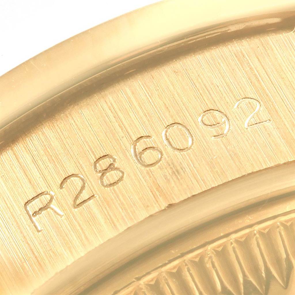 The image shows a close-up of the serial number engraving on the gold case back of a Rolex President 69178 Women's Yellow Gold Champagne Dial 69178 Women's Yellow Gold Champagne Dial model watch.