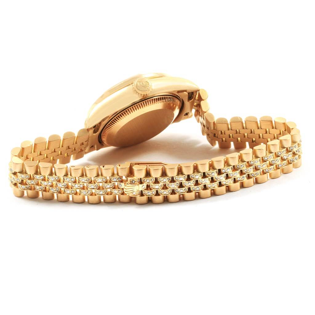 This image shows a side view of a Rolex President 69158 Women's Yellow Gold Champagne Dial 69158 Women's Yellow Gold Champagne Dial model watch, focusing on its gold case and bracelet with diamond accents.