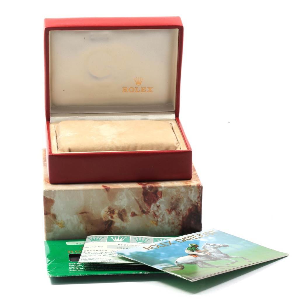 The image shows the packaging and accessories of a Rolex President 69158 Women's Yellow Gold Champagne Dial 69158 Women's Yellow Gold Champagne Dial model, including the box and informational booklets.