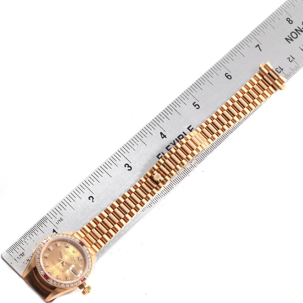 This image shows a top-down view of a Rolex President 69068 Women's Yellow Gold Champagne Dial 69068 Women's Yellow Gold Champagne Dial model watch with a ruler, highlighting the bracelet and face.
