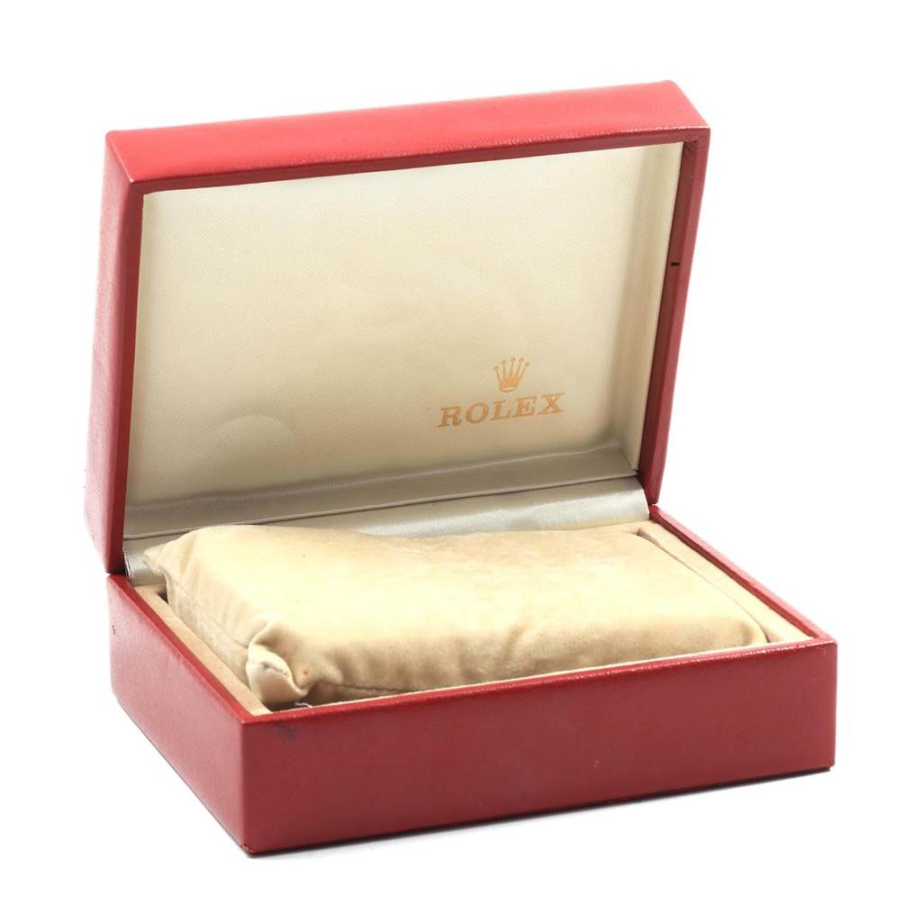 The image shows an open red Rolex watch box for the President model, with a watch cushion inside.