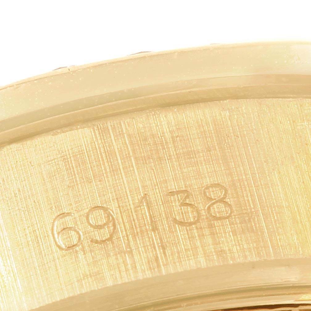 This image shows a close-up of the case number engraved inside the bezel of a Rolex President 69138 Women
s Yellow Gold Black Dial 69138 Women
s Yellow Gold Black Dial model watch.