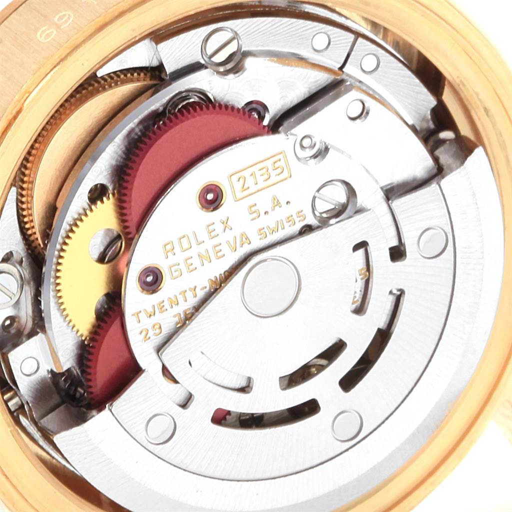 The image shows a close-up view of the internal movement of a Rolex President 69178 Women's Yellow Gold White Dial 69178 Women's Yellow Gold White Dial model watch, highlighting gears and the rotor.
