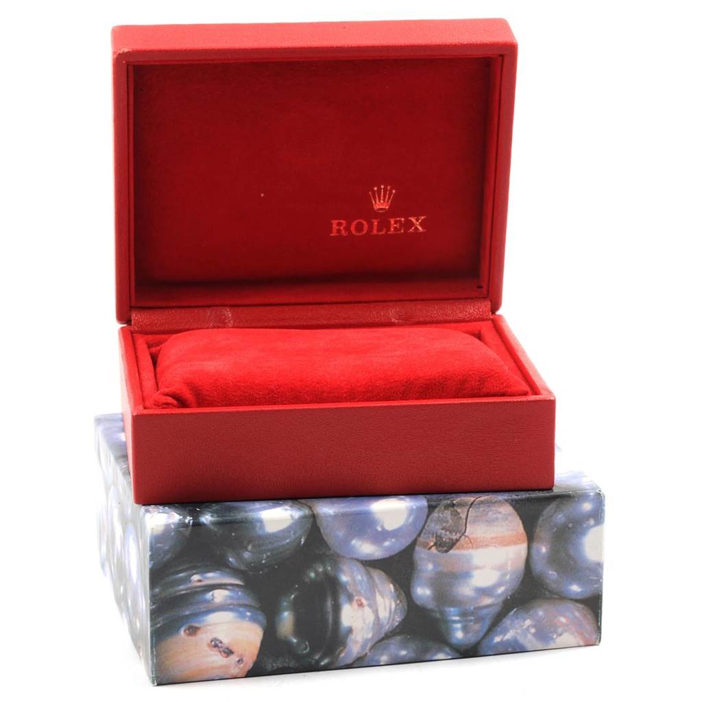 This image shows an open red Rolex box for the President model, with an empty red cushion inside.