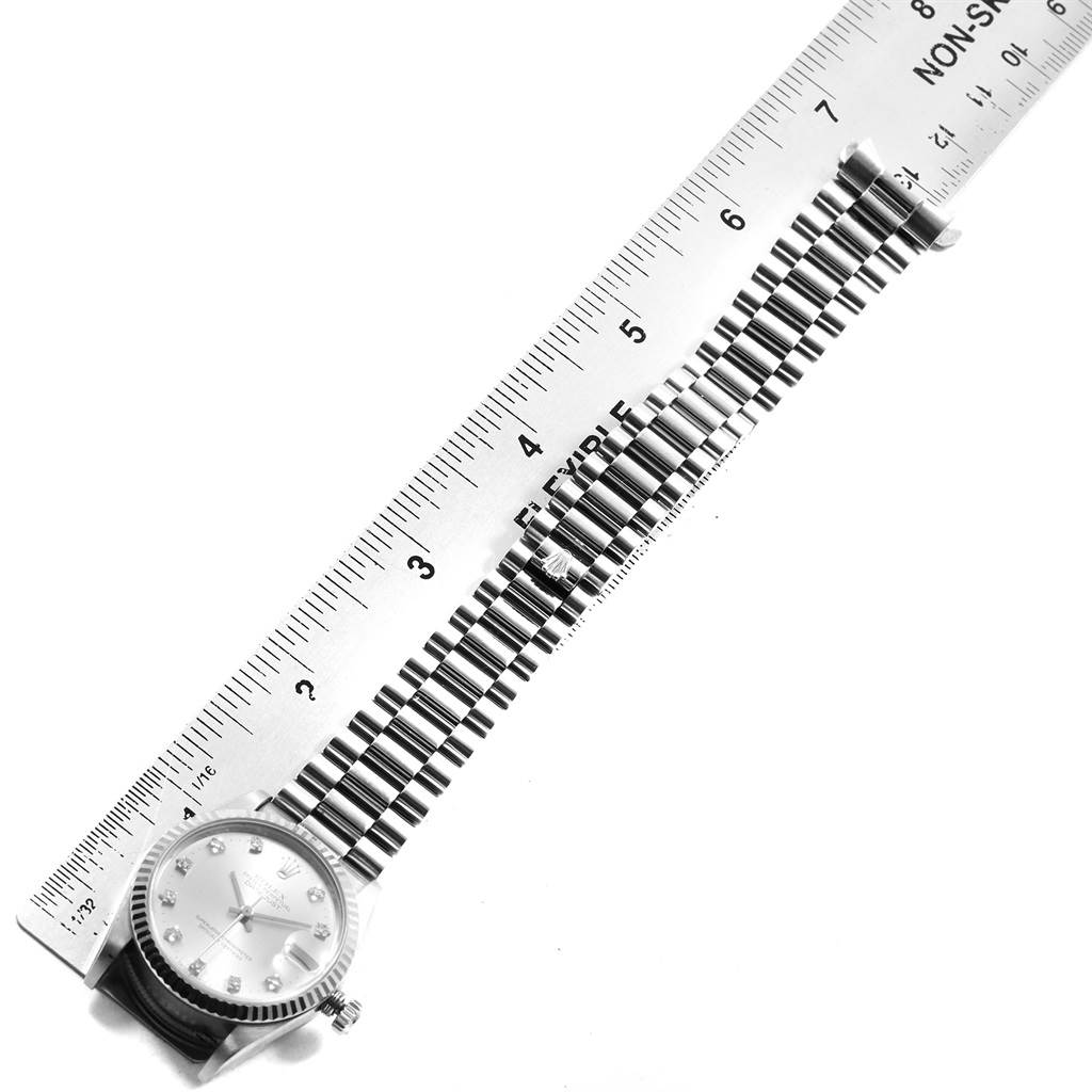 The image shows a Rolex President 68279 Women's White Gold Silver Dial 68279 Women's White Gold Silver Dial model watch with its face and bracelet with a ruler measuring the bracelet length.