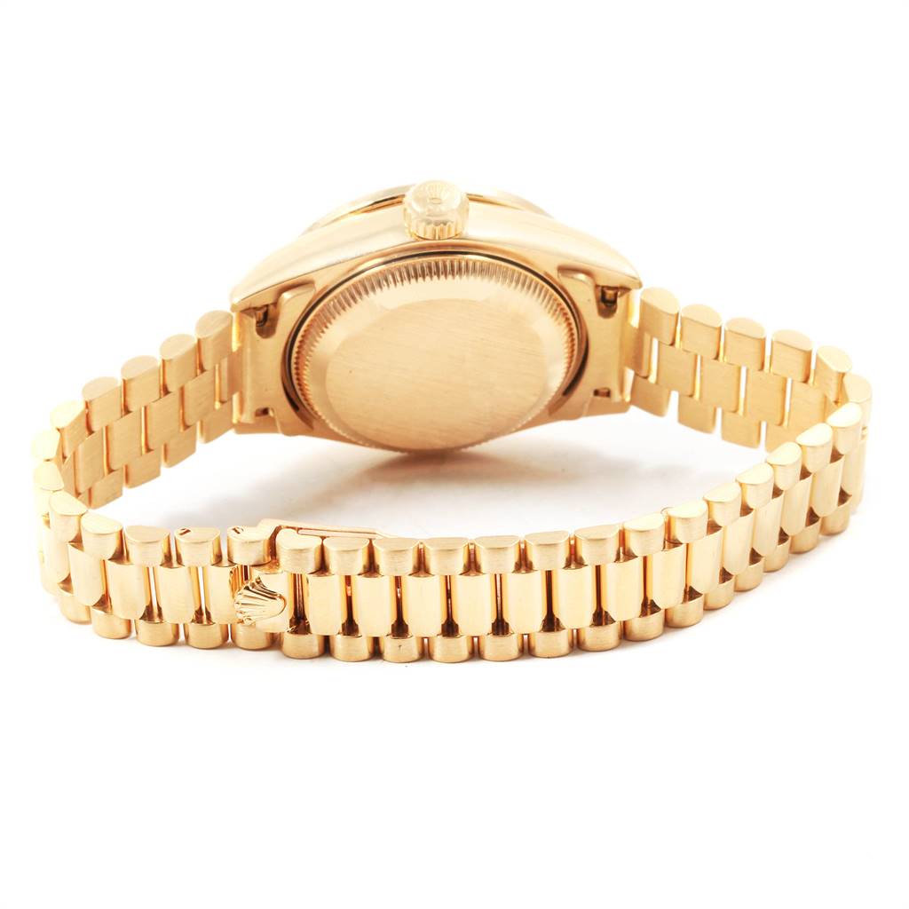 The image shows the back of a Rolex President 79088 Women
s Yellow Gold Mother of Pearl Dial 79088 Women
s Yellow Gold Mother of Pearl Dial model watch, highlighting the case back and bracelet.