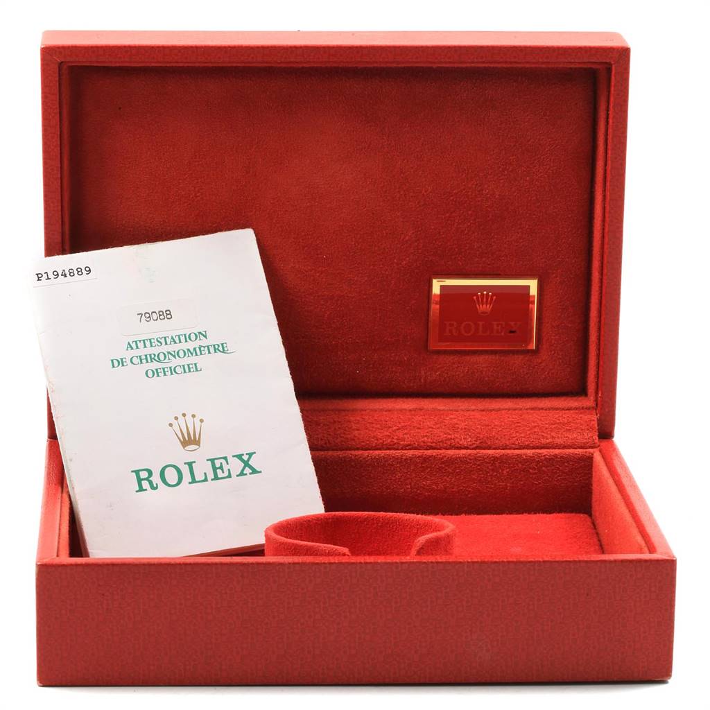 This image shows an open red Rolex watch box with documentation for the President model.