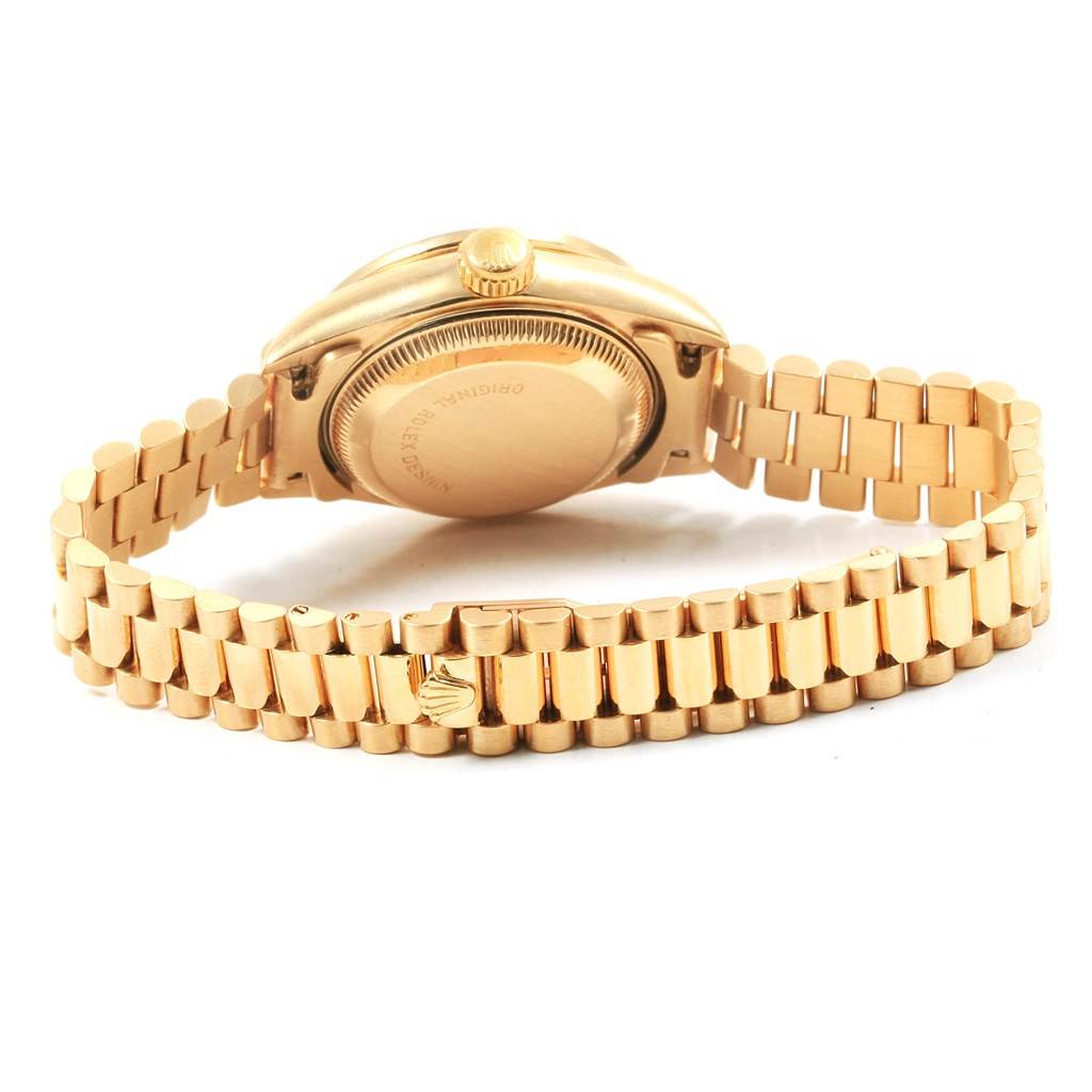 This image shows the back and bracelet of a Rolex President 69138 Women
s Yellow Gold Champagne Dial 69138 Women
s Yellow Gold Champagne Dial model watch from a low rear angle.