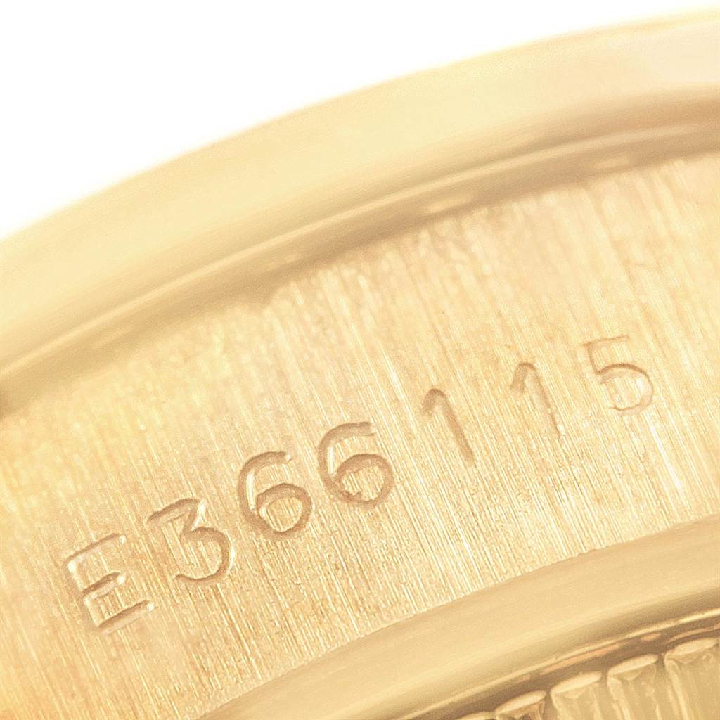 This close-up image shows the serial number engraved on the case of a Rolex President 69138 Women
s Yellow Gold Champagne Dial 69138 Women
s Yellow Gold Champagne Dial model watch.