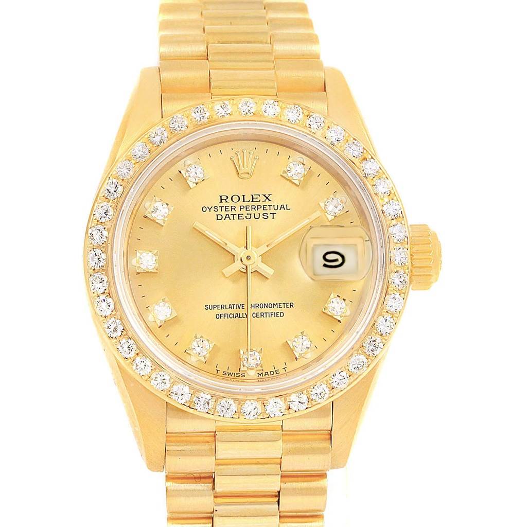 The Rolex President 69138 Women
s Yellow Gold Champagne Dial 69138 Women
s Yellow Gold Champagne Dial model watch is shown head-on, displaying its diamond-studded bezel, dial, and date window at 3 o
clock.