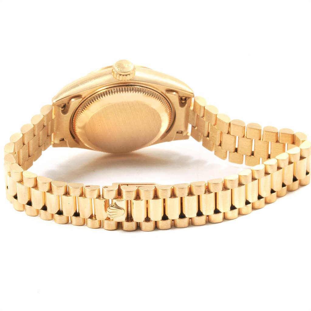 The image shows the back case and bracelet of a Rolex President 69178 Women
s Yellow Gold Champagne Dial 69178 Women
s Yellow Gold Champagne Dial model watch, angled to display the clasp and the watch
s underside.