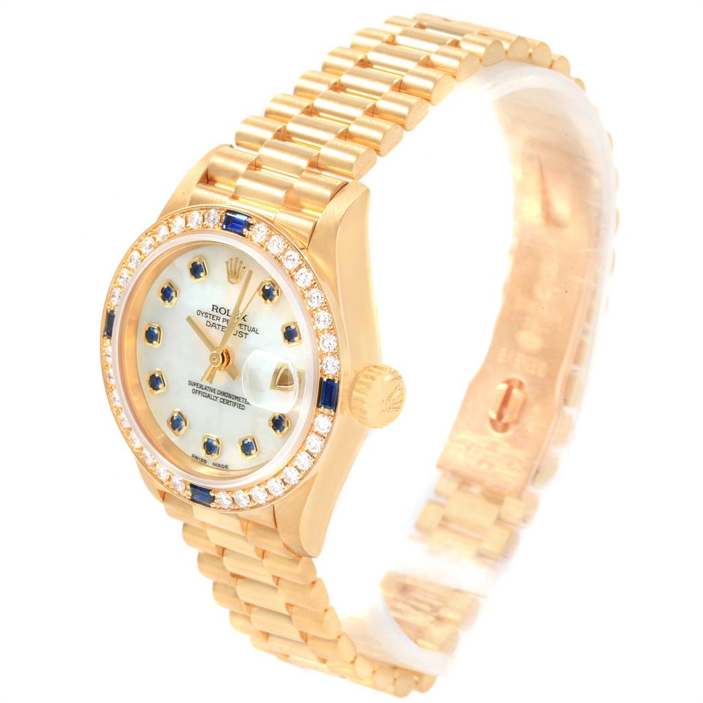 The image shows a Rolex President 79088 Women's Yellow Gold Mother of Pearl Dial 79088 Women's Yellow Gold Mother of Pearl Dial watch at an angled side view, featuring its bracelet, crown, bezel, and dial.