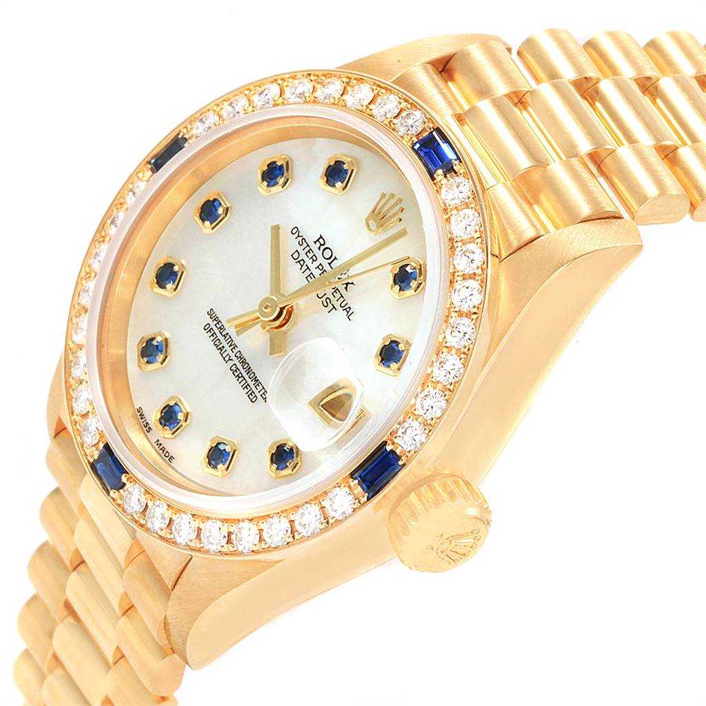 The image shows a side angle of a Rolex President 79088 Women's Yellow Gold Mother of Pearl Dial 79088 Women's Yellow Gold Mother of Pearl Dial watch, highlighting the bezel, dial, crown, and bracelet.