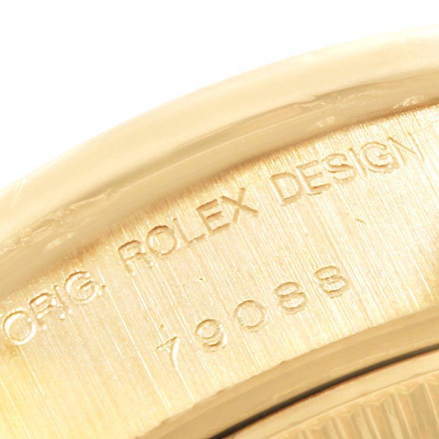 This image shows a close-up of the edge of a Rolex President 79088 Women's Yellow Gold Mother of Pearl Dial 79088 Women's Yellow Gold Mother of Pearl Dial model with "ORG. ROLEX DESIGN" and the number 79088 engraved.