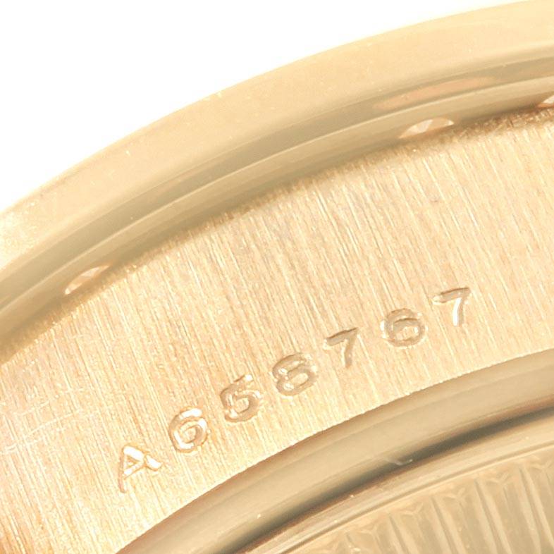 This close-up image shows the serial number engraved on the case back of a Rolex President 79088 Women's Yellow Gold Mother of Pearl Dial 79088 Women's Yellow Gold Mother of Pearl Dial model watch.