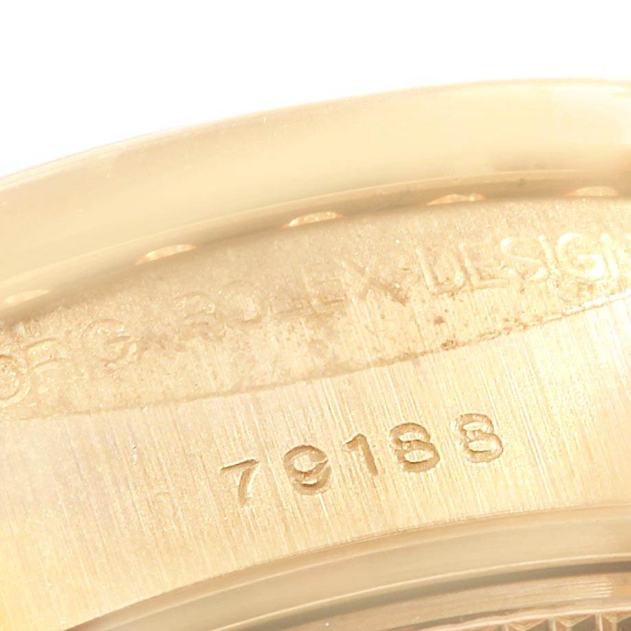 This image shows a close-up view of the Rolex President 79188 Women
s Yellow Gold Champagne Dial 79188 Women
s Yellow Gold Champagne Dial model, focusing on the inside of the watch case with engraved inscriptions and numbers.