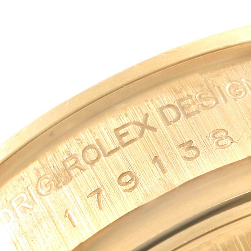 This close-up image shows the engraved serial number and part of the inner bezel of a Rolex President 179138 Women's Yellow Gold Mother of Pearl Dial 179138 Women's Yellow Gold Mother of Pearl Dial model.