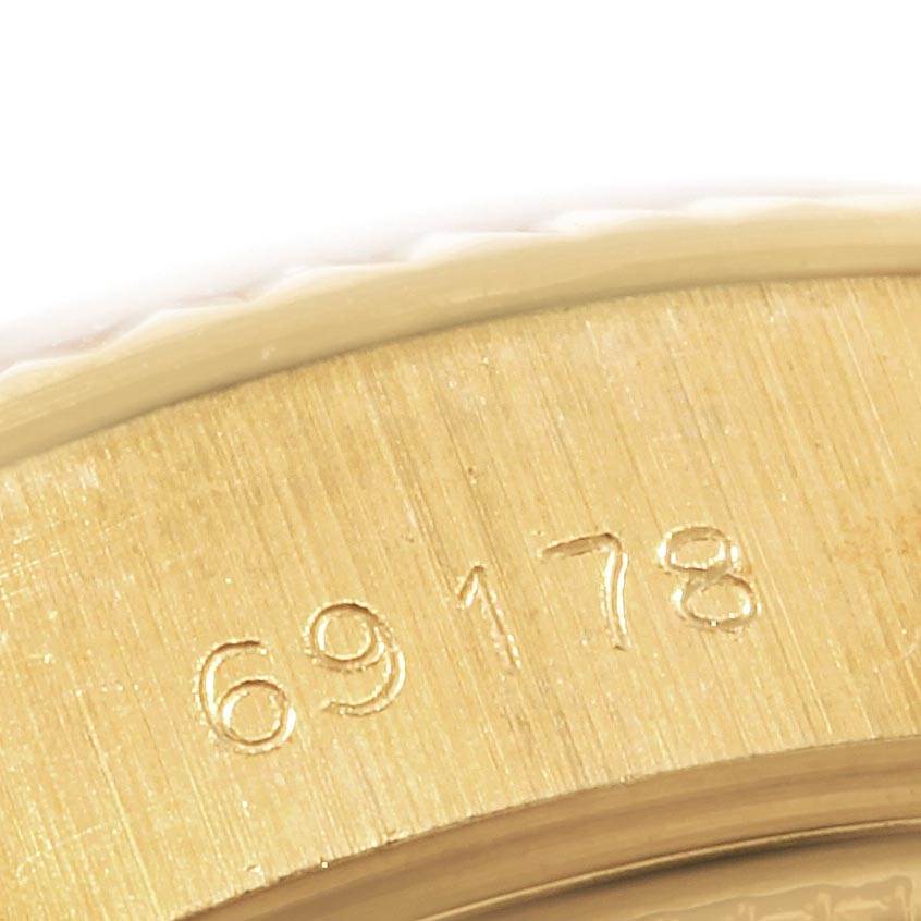 This close-up image of a Rolex President 69178 Women
s Yellow Gold Silver Dial 69178 Women
s Yellow Gold Silver Dial model watch shows the engraved model number 69178 on the gold case.