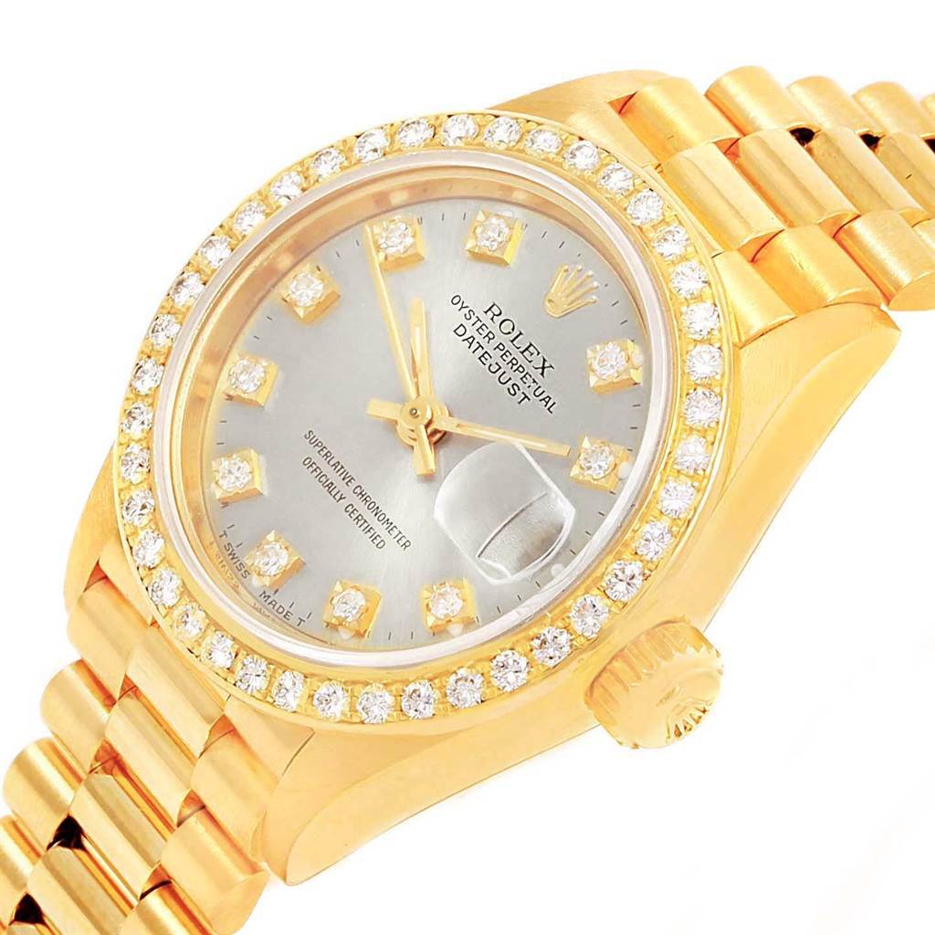 The image shows a close-up view of the Rolex President 69178 Women
s Yellow Gold Silver Dial 69178 Women
s Yellow Gold Silver Dial model watch with a gold band, diamond bezel, and silver dial.