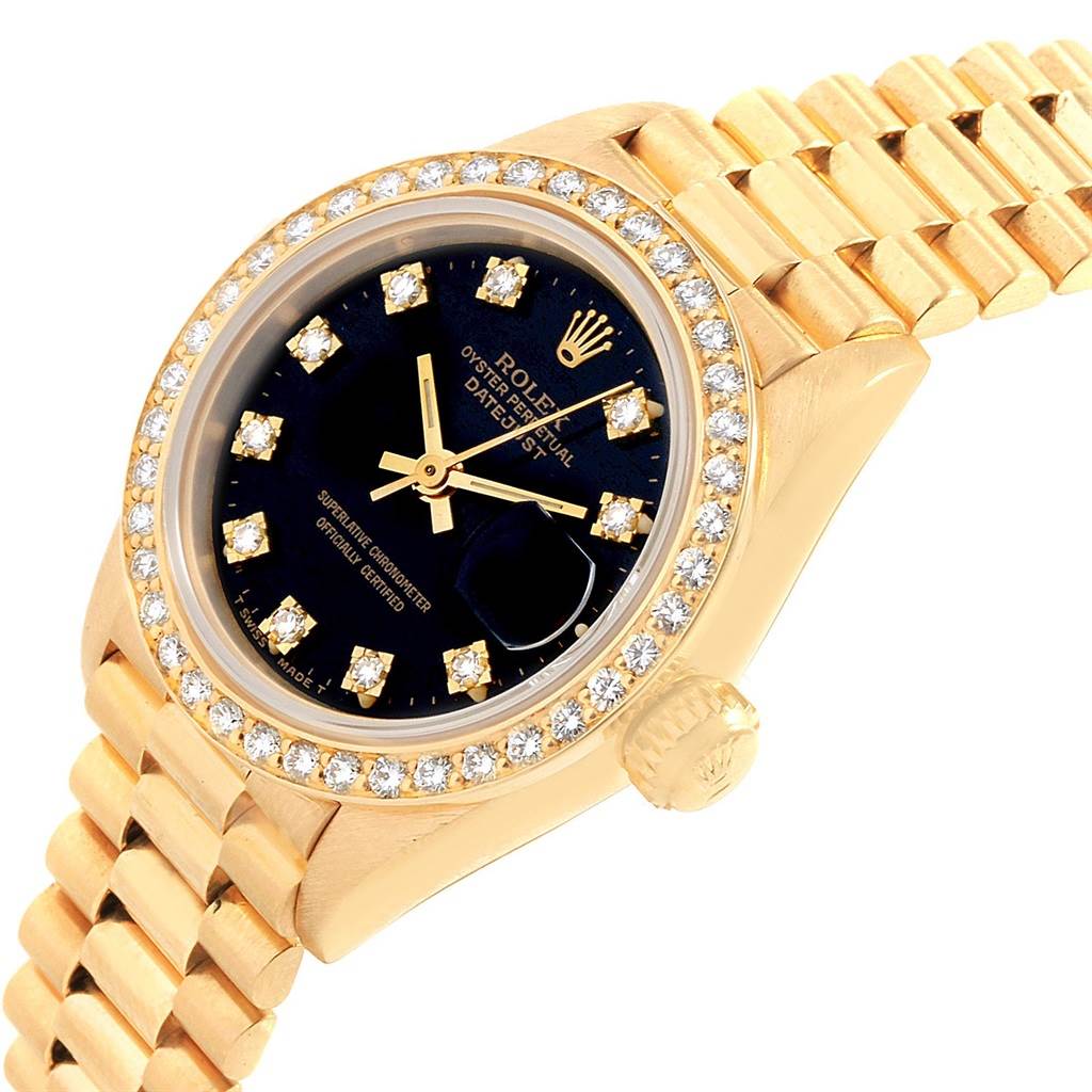 The image shows a close-up of the dial, bezel, crown, and part of the bracelet of a Rolex President 69138 Women's Yellow Gold Black Dial 69138 Women's Yellow Gold Black Dial model watch.