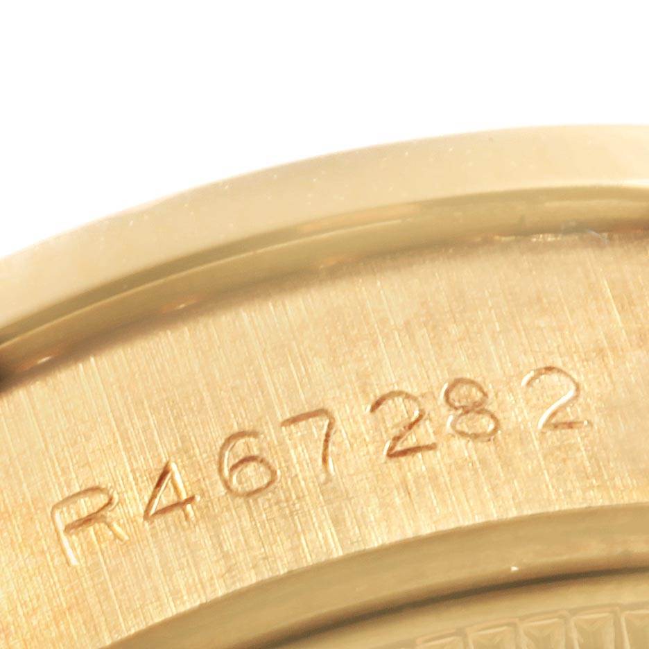This image shows a close-up of the Rolex President 69138 Women's Yellow Gold Black Dial 69138 Women's Yellow Gold Black Dial model's case back with the serial number engraved.
