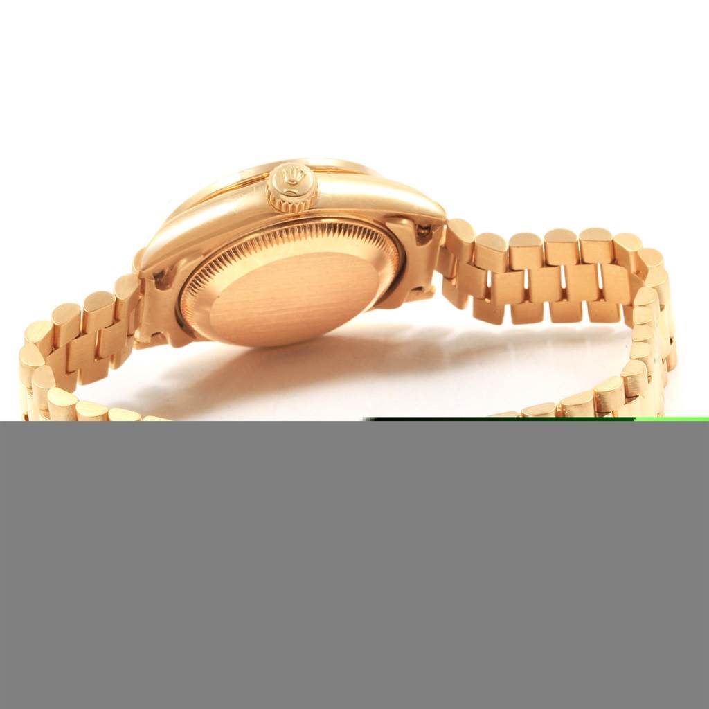 The image shows the side angle of the Rolex President 69138 Women's Yellow Gold Black Dial 69138 Women's Yellow Gold Black Dial model watch, highlighting the crown, bezel, case back, and part of the bracelet.