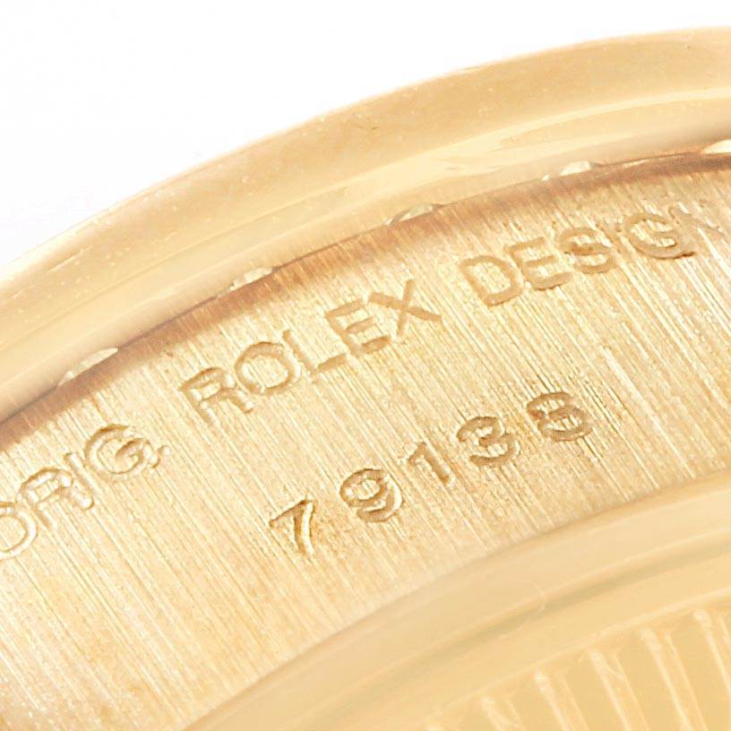 The image shows a close-up angle of the engraving on the case of a Rolex President 79138 Women's Yellow Gold Mother of Pearl Dial 79138 Women's Yellow Gold Mother of Pearl Dial model watch.