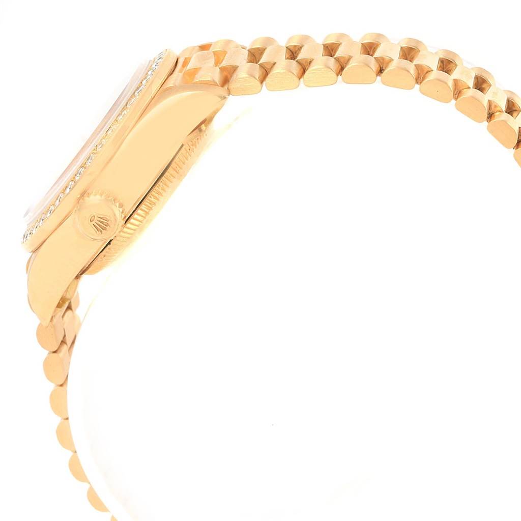 This side view image of the Rolex President 79138 Women's Yellow Gold Mother of Pearl Dial 79138 Women's Yellow Gold Mother of Pearl Dial model watch highlights its case, crown, and bracelet.